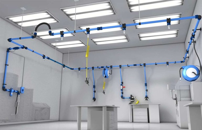 Engineer with safety gear inspecting red industrial piping system indoors.